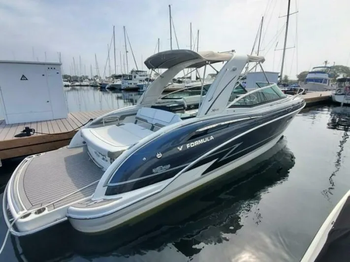  Yacht Photos Pics 2017 Formula 310SS boat docked at marina, sleek design, calm water reflection.