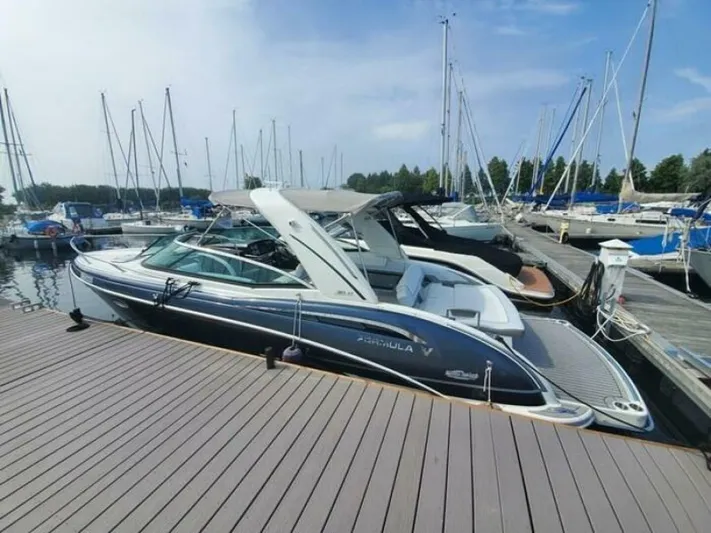 Yacht Photos Pics 2017 Formula 310SS boat docked at a marina with sailboats in the background.