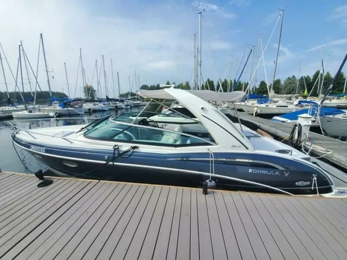  Yacht Photos Pics 2017 Formula 310SS boat docked at a marina with sailboats in the background.