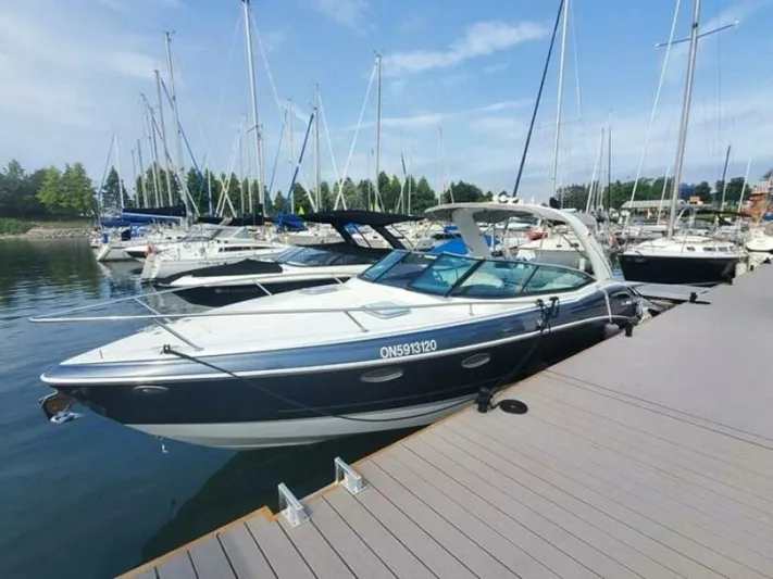  Yacht Photos Pics 2017 Formula 310SS boat docked at marina with sailboats in background.