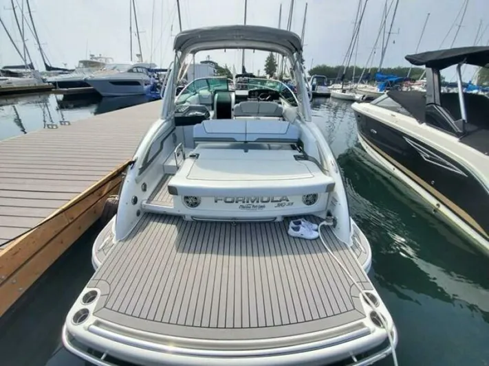  Yacht Photos Pics 2017 Formula 310SS boat docked at marina, showcasing spacious deck and sleek design.