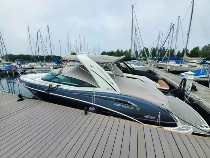  Yacht Photos Pics 2017 Formula 310SS boat docked at marina with sailboats in background.