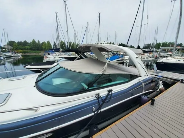  Yacht Photos Pics 2017 Formula 310SS boat docked at marina with sailboats in background.