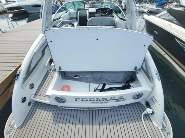  Yacht Photos Pics 2017 Formula 310SS boat with open storage compartment at marina dock.