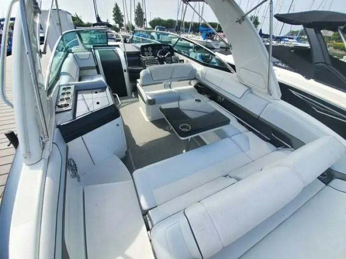  Yacht Photos Pics 2017 Formula 310SS boat interior with white seating and sleek design in a marina setting.