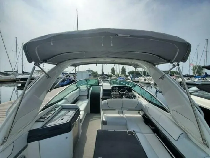  Yacht Photos Pics 2017 Formula 310SS boat interior with seating and canopy at marina.