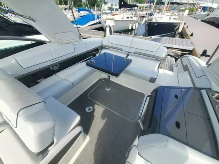  Yacht Photos Pics 2017 Formula 310SS boat interior with seating and table, docked at marina.