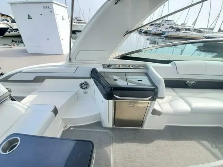  Yacht Photos Pics 2017 Formula 310SS boat interior with seating and kitchenette, docked at marina.