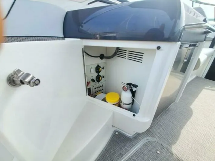  Yacht Photos Pics 2017 Formula 310SS boat storage compartment with safety equipment and controls.