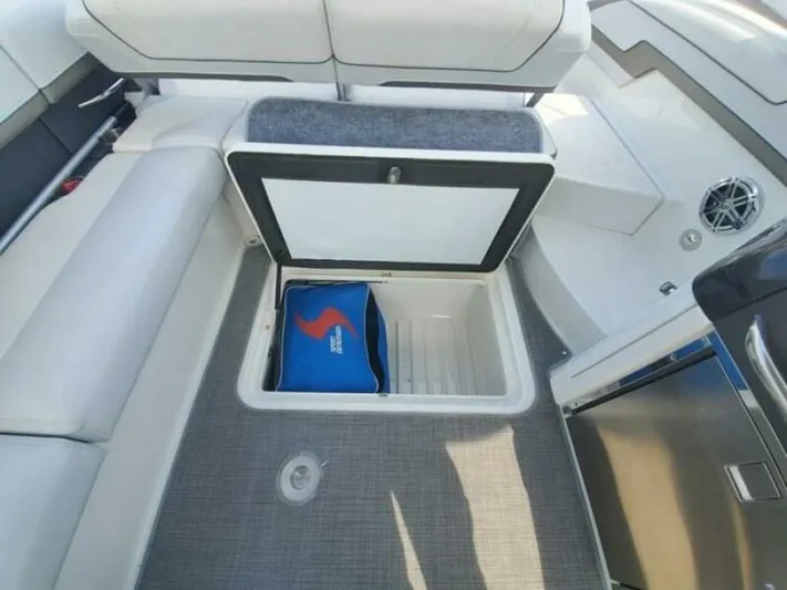  Yacht Photos Pics 2017 Formula 310SS boat interior with open storage compartment and blue bag.