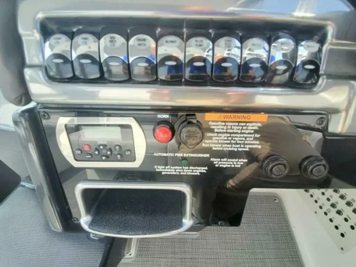  Yacht Photos Pics Control panel of a 2017 Formula 310SS boat with switches and warning labels.