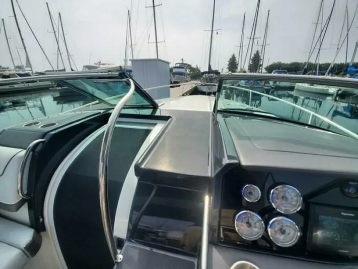  Yacht Photos Pics 2017 Formula 310SS boat dashboard with gauges, docked at marina with sailboats.