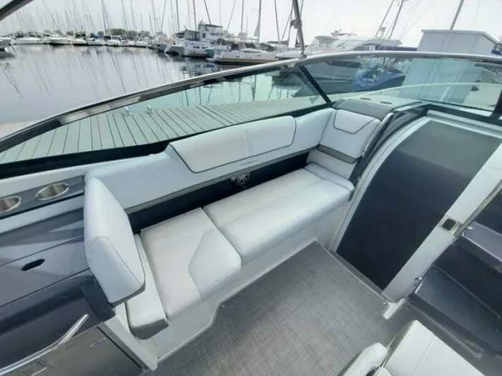  Yacht Photos Pics 2017 Formula 310SS boat interior with white seating, docked at marina.