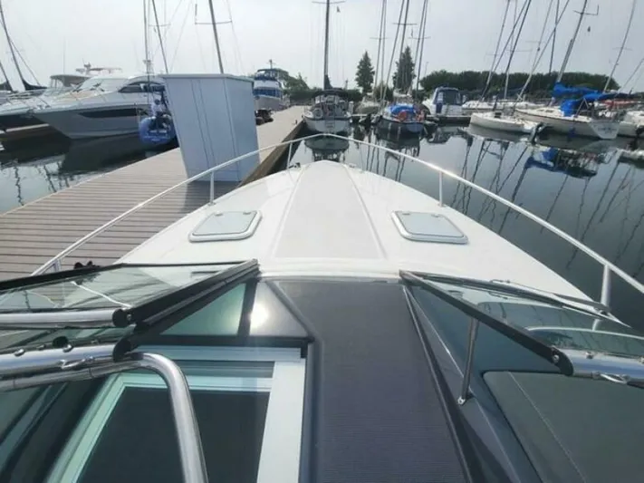  Yacht Photos Pics 2017 Formula 310SS boat docked at marina with sailboats in background.