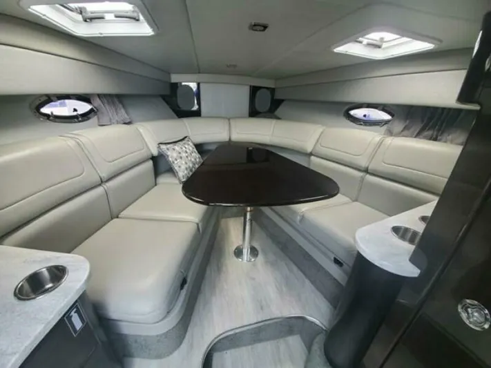  Yacht Photos Pics Luxurious interior of a 2017 Formula 310SS boat with plush seating and elegant table.