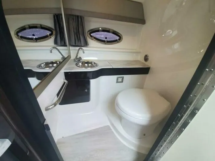  Yacht Photos Pics 2017 Formula 310SS boat bathroom with sink, toilet, and porthole windows.