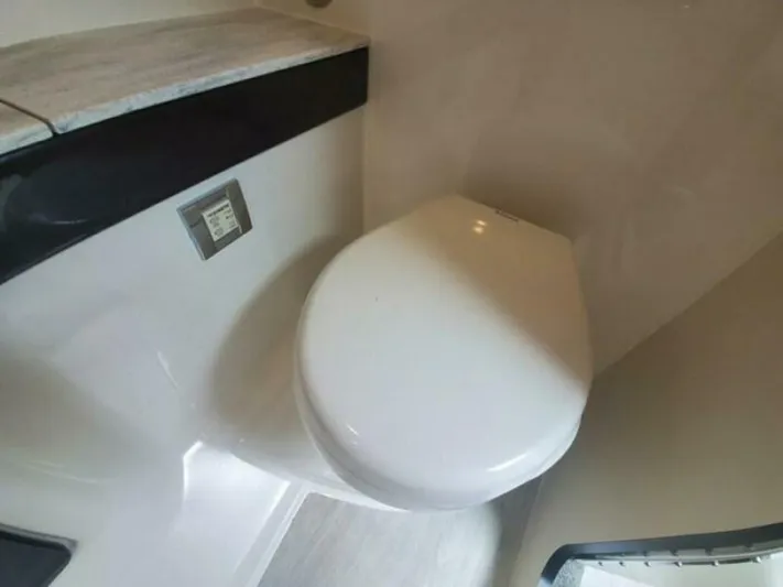  Yacht Photos Pics 2017 Formula 310SS boat bathroom with compact toilet and modern design.