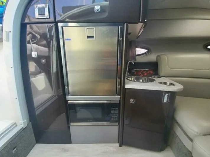 Yacht Photos Pics 2017 Formula 310SS interior with stainless steel fridge and compact kitchenette.