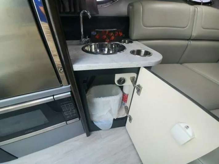  Yacht Photos Pics 2017 Formula 310SS interior with kitchenette, featuring sink, microwave, and storage cabinet.