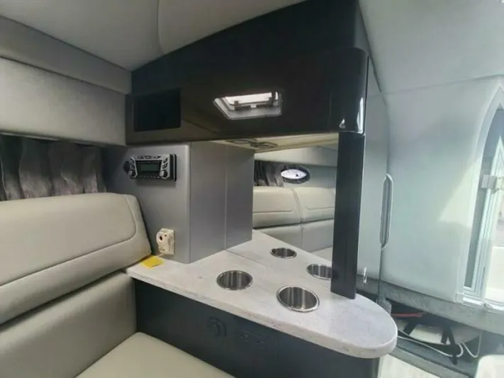  Yacht Photos Pics Interior of a 2017 Formula 310SS boat, featuring seating and a cup holder console.