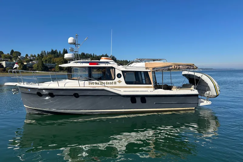 Two For The Road II Yacht Photos Pics 2020 Ranger Tugs R-29 boat on calm water, clear sky background.