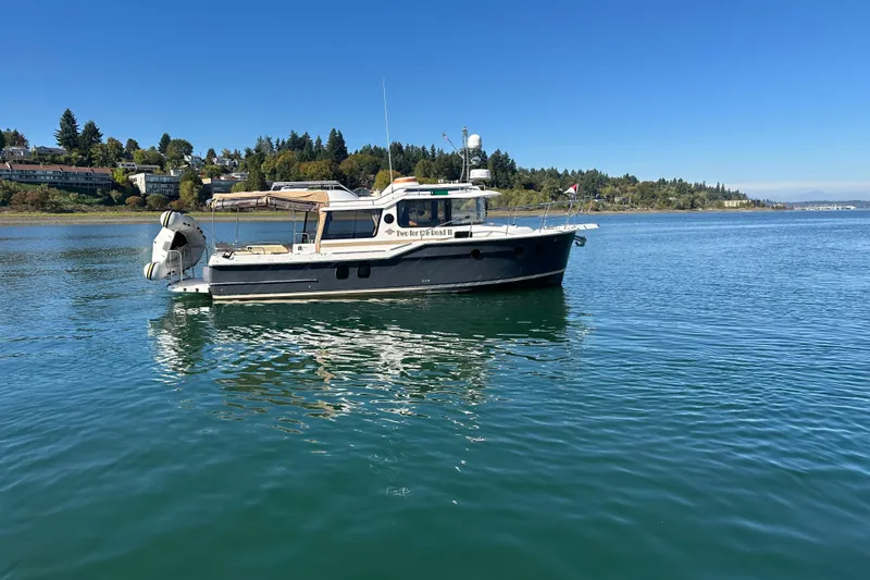 Two For The Road II Yacht Photos Pics 2020 Ranger Tugs R-29 boat on calm water, scenic shoreline background.