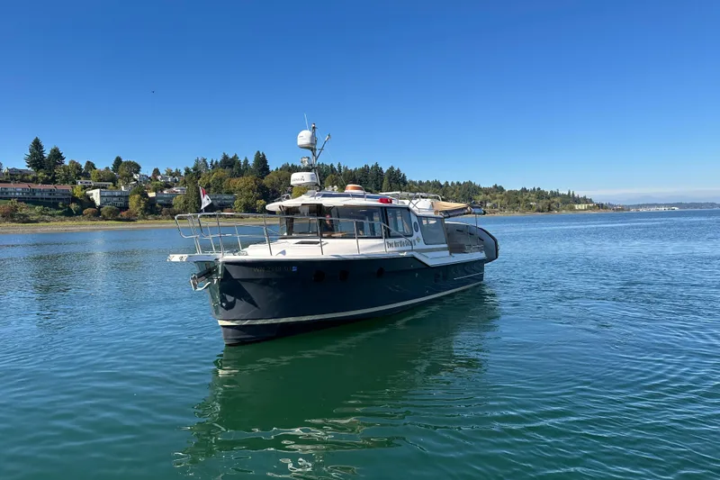 Two For The Road II Yacht Photos Pics 2020 Ranger Tugs R-29 boat on calm water, scenic shoreline background.