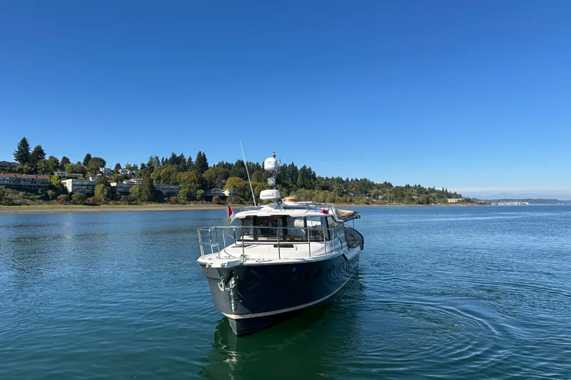 Two For The Road II Yacht Photos Pics 2020 Ranger Tugs R-29 boat on calm water with scenic shoreline background.