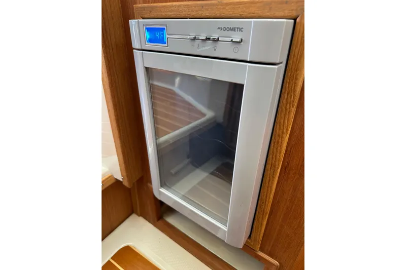 Two For The Road II Yacht Photos Pics Dometic refrigerator in 2020 Ranger Tugs R-29 boat interior, wooden paneling.