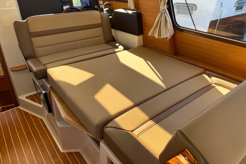 Two For The Road II Yacht Photos Pics Interior of 2020 Ranger Tugs R-29 with beige seating and wood accents.