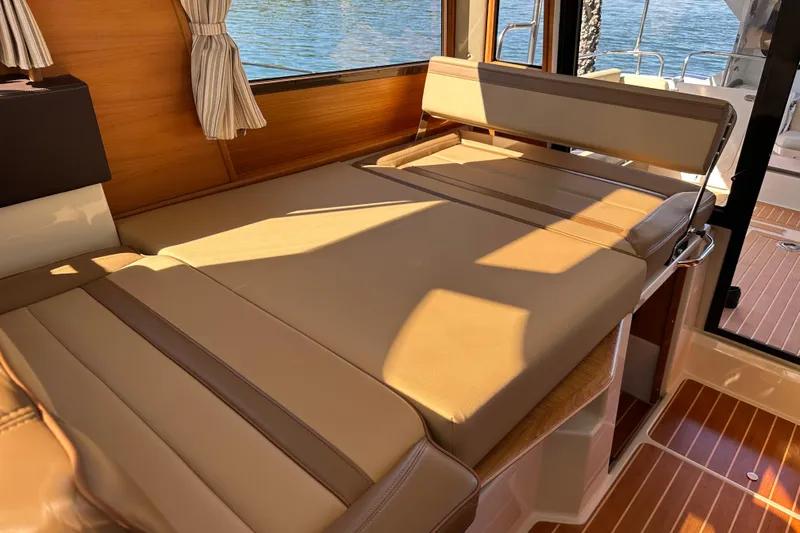 Two For The Road II Yacht Photos Pics Interior of 2020 Ranger Tugs R-29 with beige seating and wooden accents.