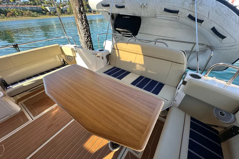 Two For The Road II Yacht Photos Pics 2020 Ranger Tugs R-29 boat interior with seating and wooden table on deck.