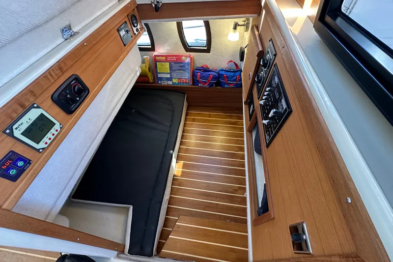 Two For The Road II Yacht Photos Pics Interior cabin of 2020 Ranger Tugs R-29 with wood paneling and control panels.