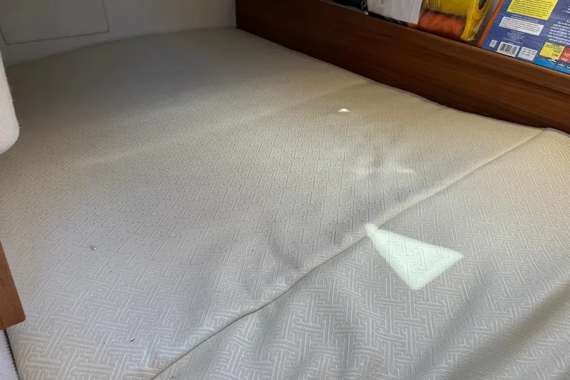 Two For The Road II Yacht Photos Pics Interior cabin bed of 2020 Ranger Tugs R-29 boat, featuring patterned bedding.