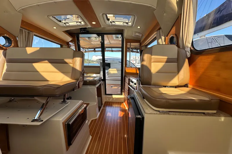 Two For The Road II Yacht Photos Pics Interior of 2020 Ranger Tugs R-29 boat with luxurious seating and wood finishes.
