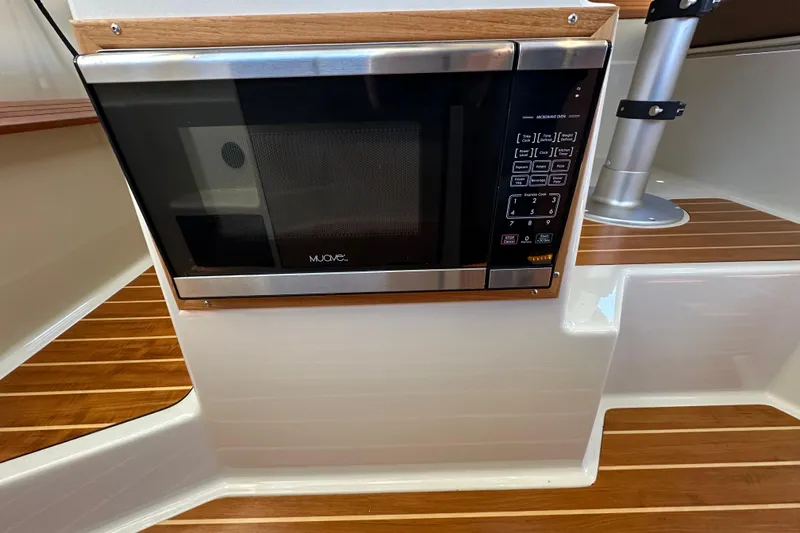 Two For The Road II Yacht Photos Pics Microwave oven in 2020 Ranger Tugs R-29 boat interior with wood accents.