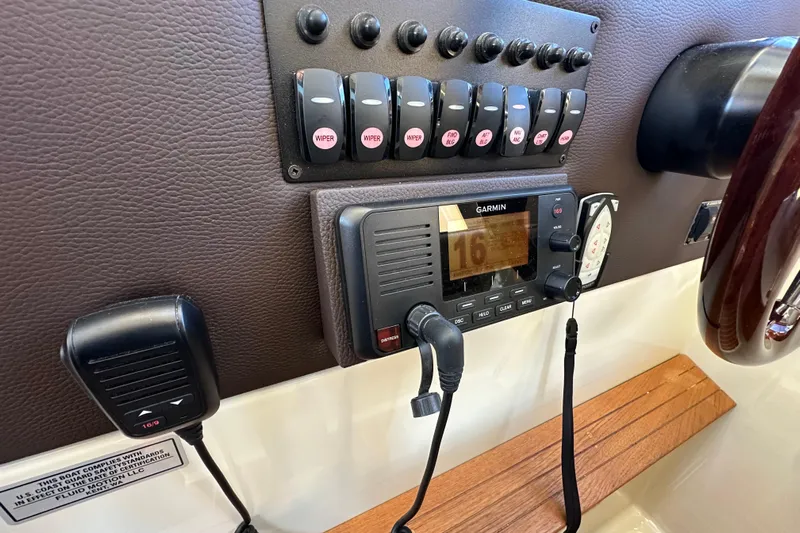 Two For The Road II Yacht Photos Pics Control panel of 2020 Ranger Tugs R-29 with Garmin marine radio and switches.