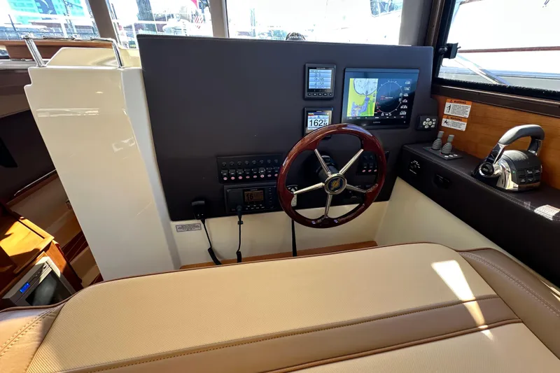 Two For The Road II Yacht Photos Pics 2020 Ranger Tugs R-29 helm with navigation controls and steering wheel.