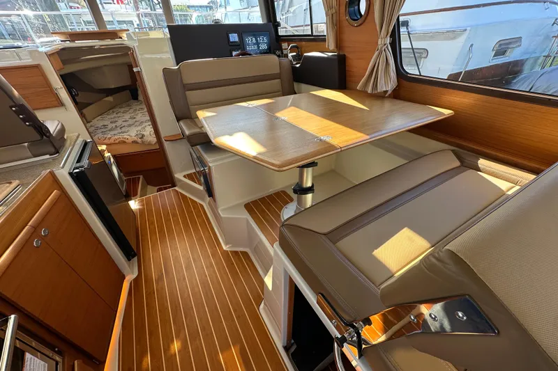 Two For The Road II Yacht Photos Pics Interior of 2020 Ranger Tugs R-29 with wood flooring and dining area.