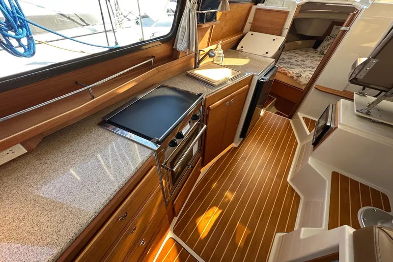 Two For The Road II Yacht Photos Pics 2020 Ranger Tugs R-29 interior with modern kitchen and cozy cabin space.