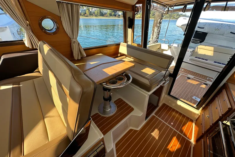 Two For The Road II Yacht Photos Pics Interior of 2020 Ranger Tugs R-29 boat with seating and wooden flooring.