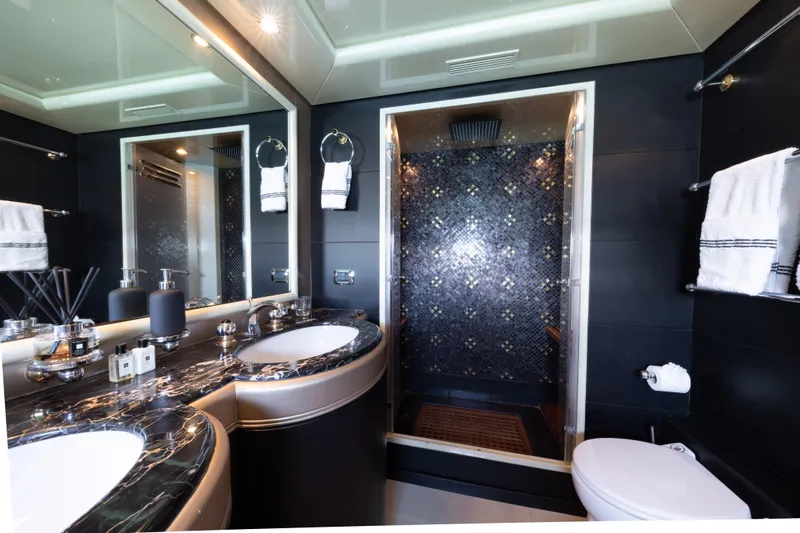 Lauren V Yacht Photos Pics Luxurious bathroom in 1997 Mangusta 103 yacht with elegant fixtures and modern design.