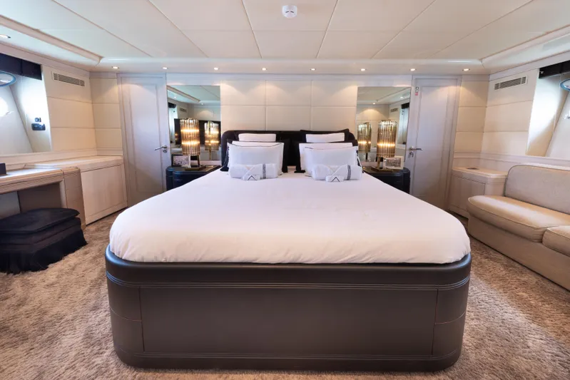 Lauren V Yacht Photos Pics Luxurious bedroom interior on 1997 Mangusta 103 yacht, featuring elegant design and plush bedding.