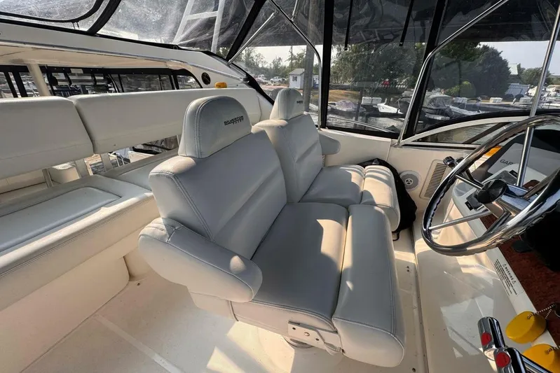  Yacht Photos Pics 2004 Silverton 35 Motor Yacht interior with plush seating and steering wheel.