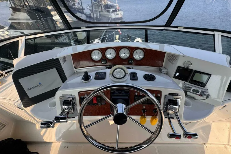  Yacht Photos Pics 2004 Silverton 35 Motor Yacht helm with Garmin navigation, steering wheel, and control panel.
