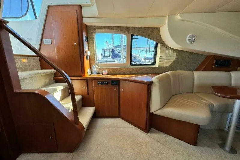  Yacht Photos Pics Interior of 2004 Silverton 35 Motor Yacht with wooden cabinetry and beige seating.