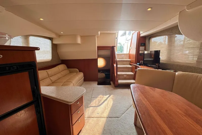  Yacht Photos Pics Interior of 2004 Silverton 35 Motor Yacht with cozy seating and wooden finishes.