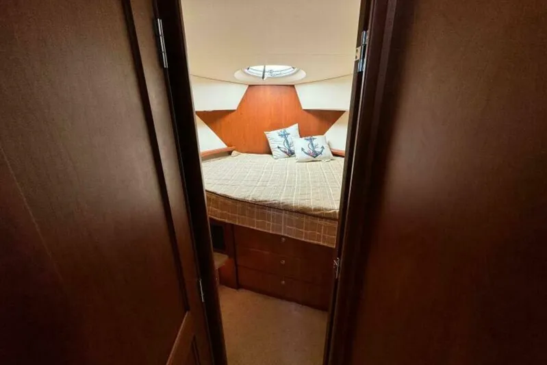  Yacht Photos Pics Cozy bedroom in 2004 Silverton 35 Motor Yacht with nautical-themed pillows.