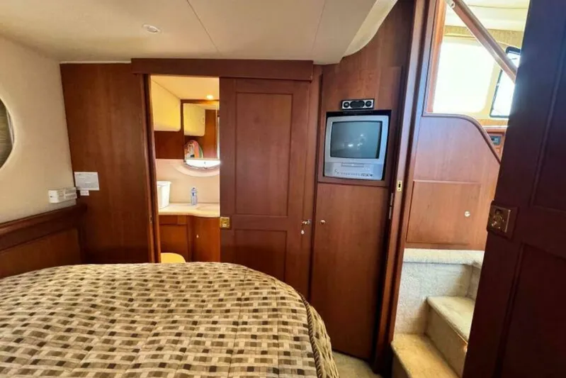  Yacht Photos Pics Interior of 2004 Silverton 35 Motor Yacht with TV, bed, and stairs.
