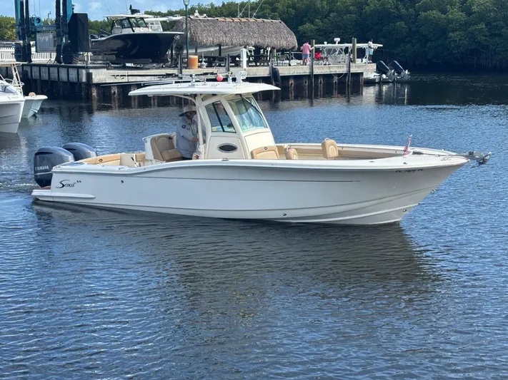  Yacht Photos Pics Scout 282 XSF 2013 boat on calm water near dock.